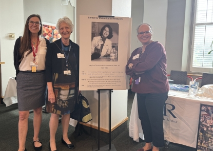 Beulah Sabundayo, Ellen McKenzie and Kawsar Talaat posing with poster of CIR founder Mary Lou Clements-Mann
